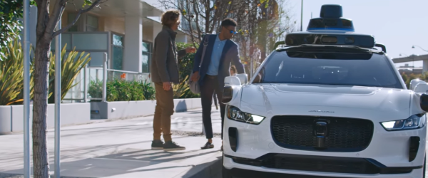 Two mens are boarding on Waymo robotaxi