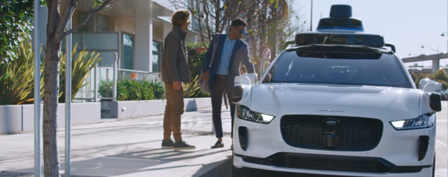 Two mens are boarding on Waymo robotaxi